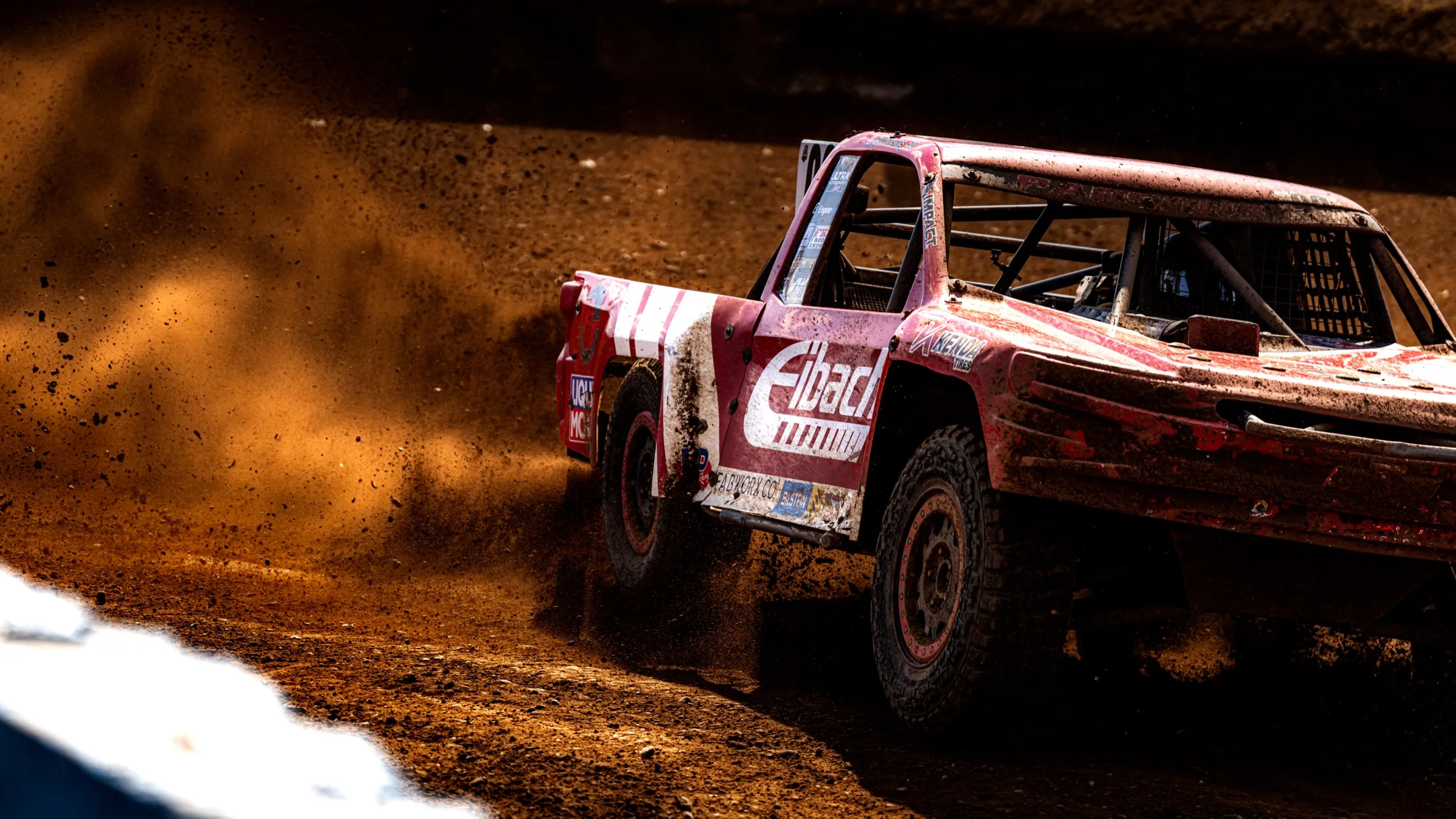 Off-road truck throwing dirt